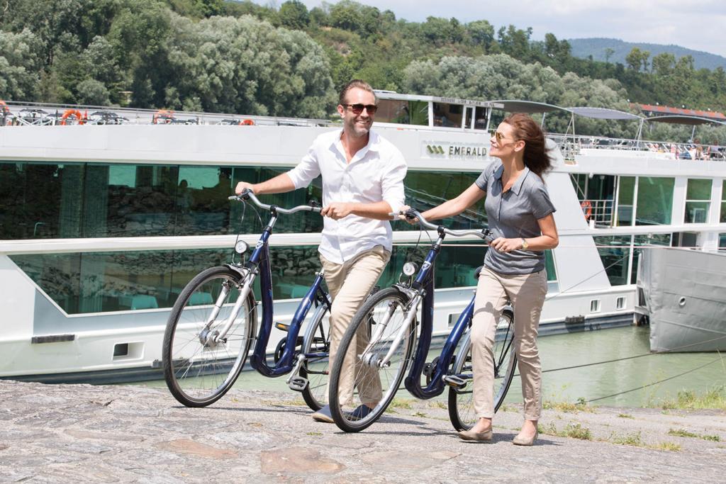 Couple enjoy complimentary bike tour off-shore during Emerald Sun river cruise