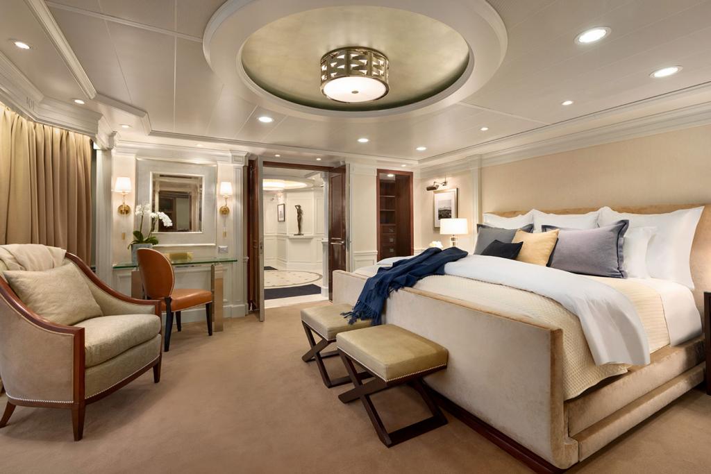 Oceania Riviera's revamped Owner's Suite with Ralph Lauren king-size bed and chairs